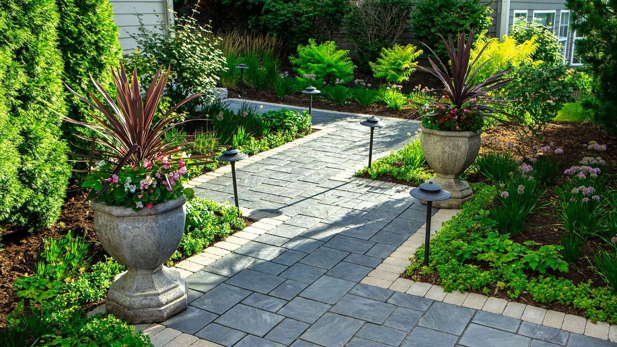 container gardens line paver walkway