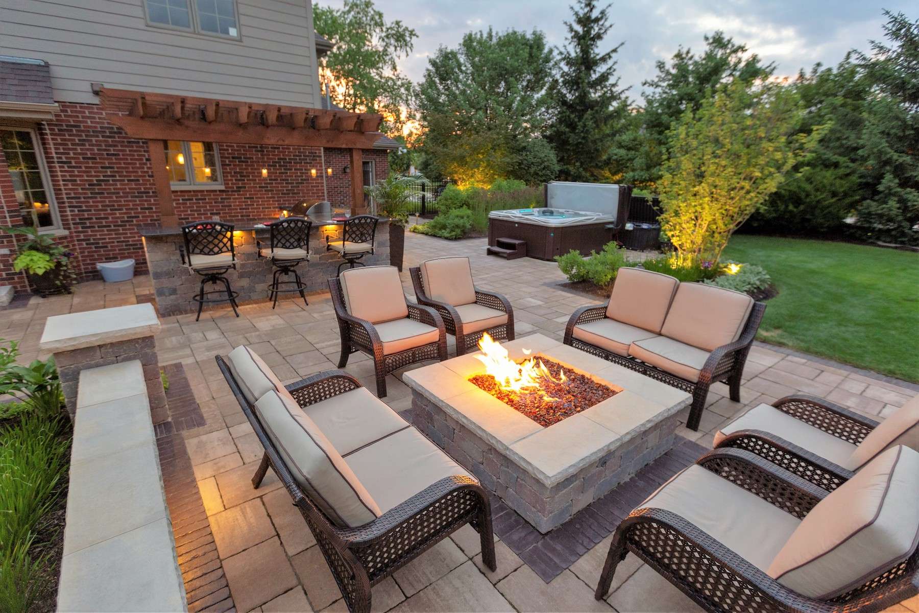 firepit on patio with pergola bar and hot tub