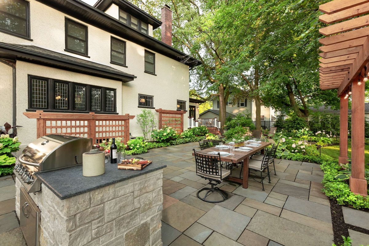 patio with outdoor kitchen and plantings