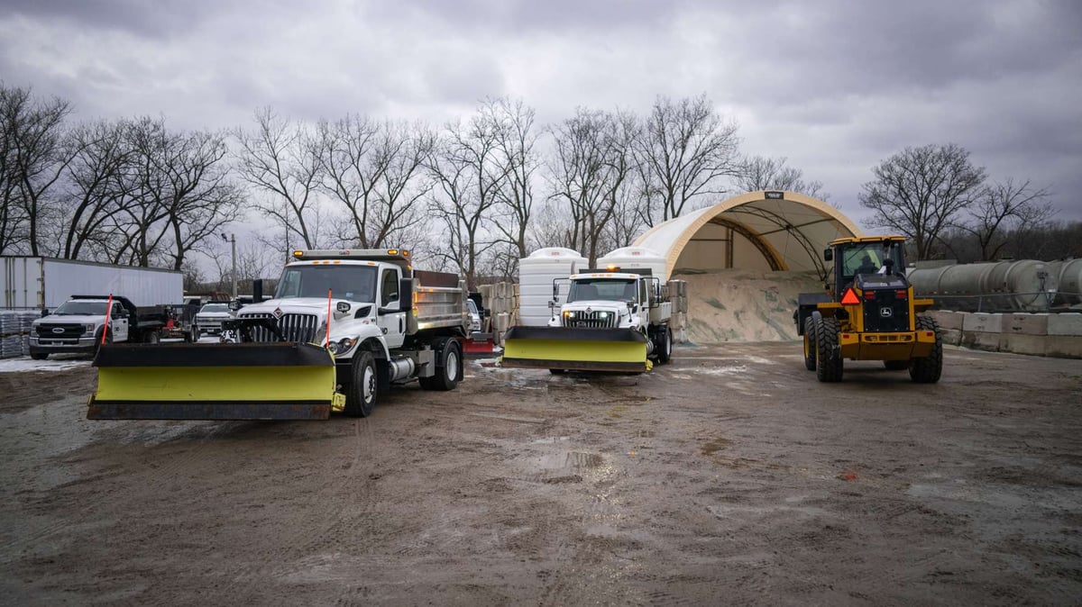 salt stored at landscaping yard with snow removal trucks
