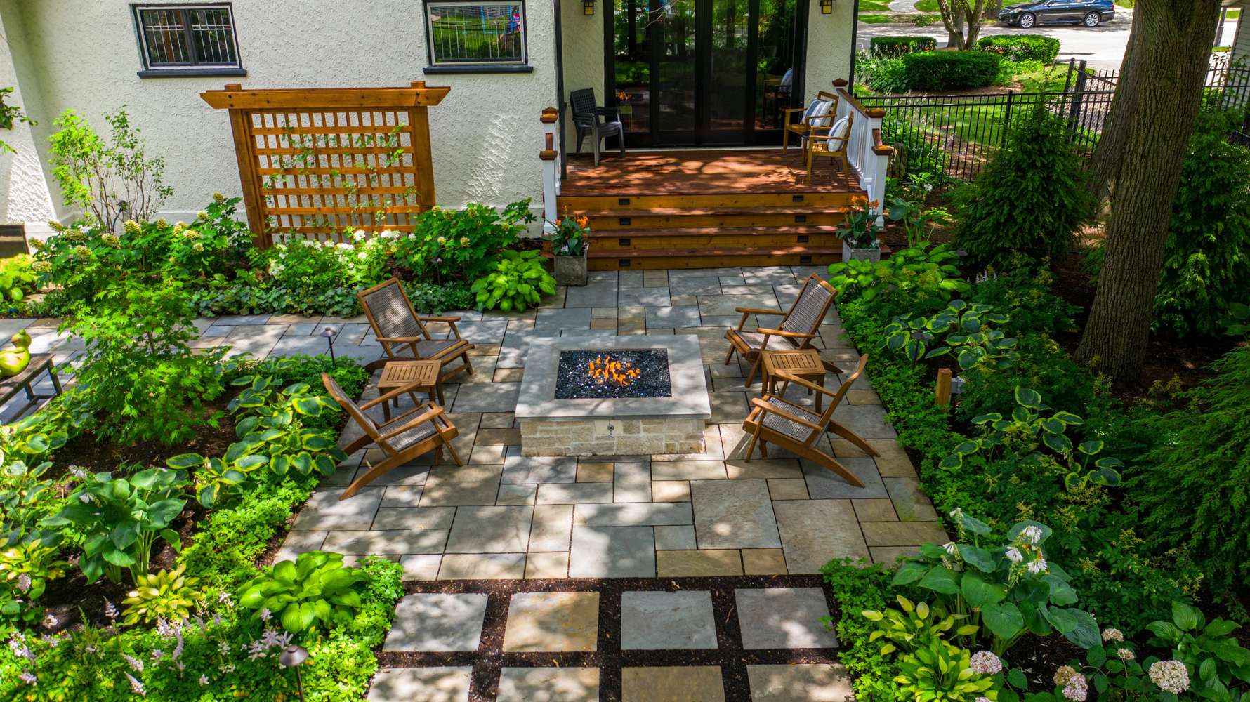 aerial view of custom patio with fire pit and seating