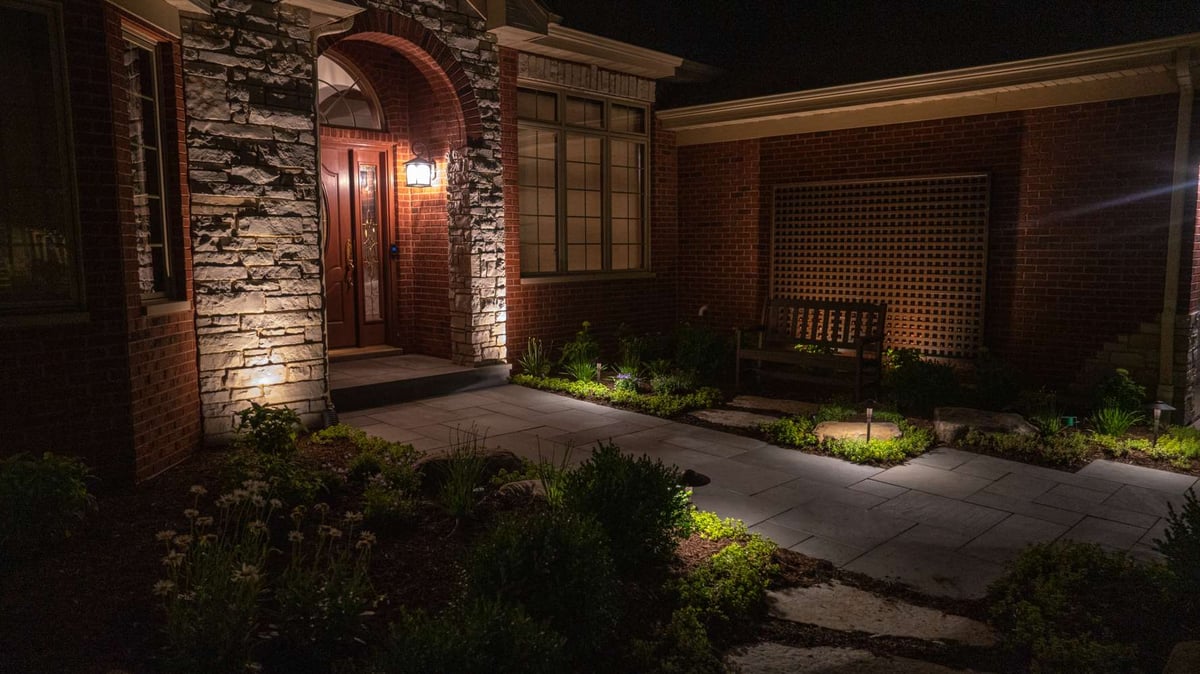 walkway to front door with plantings and landscape lighting