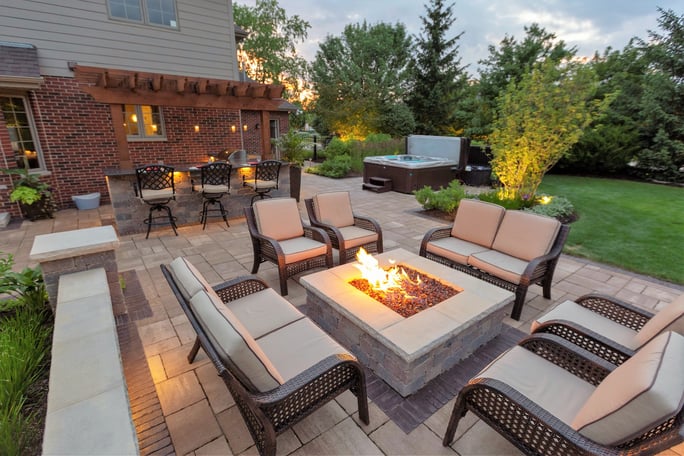 fire pit patio and sitting wall in backyard landscape