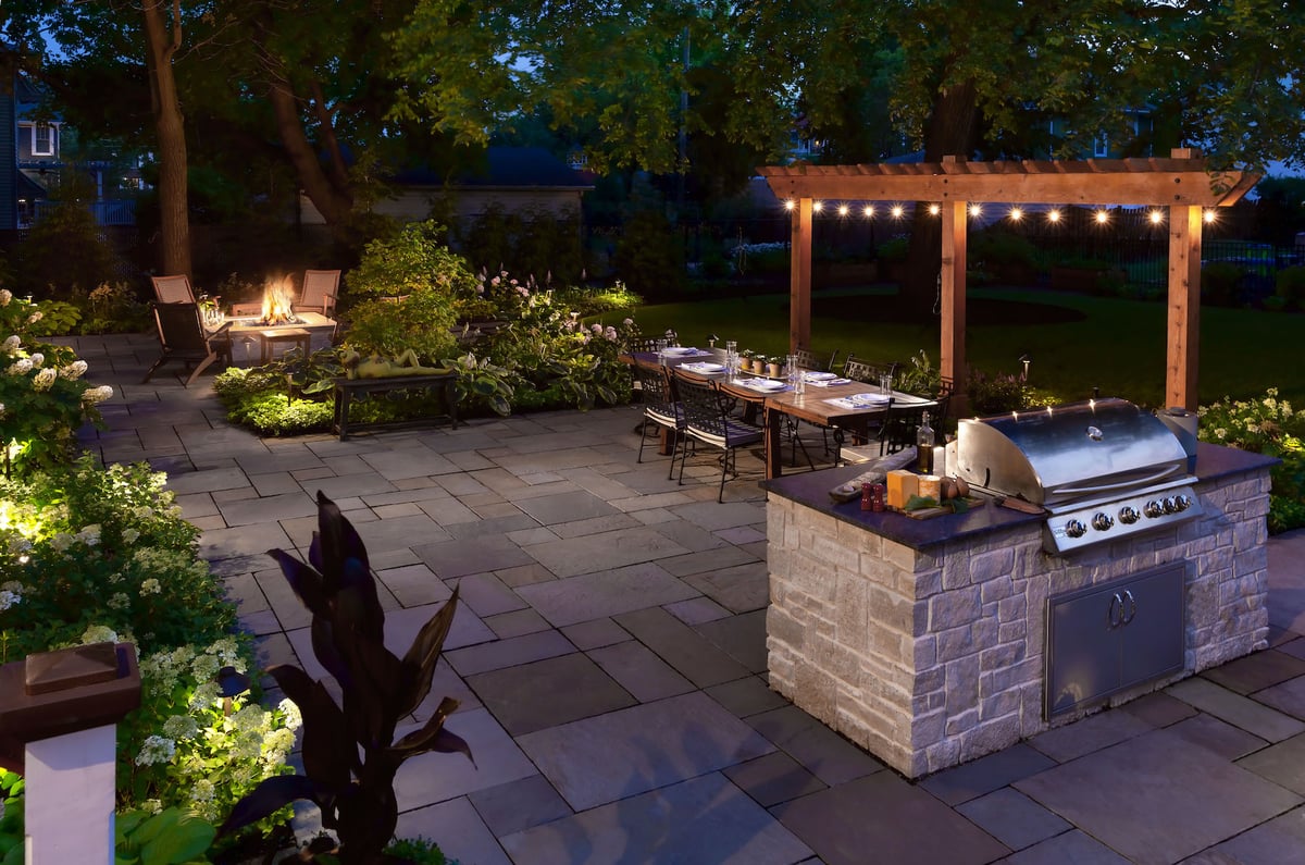 outdoor kitchen pergola and patio with landscape lighting