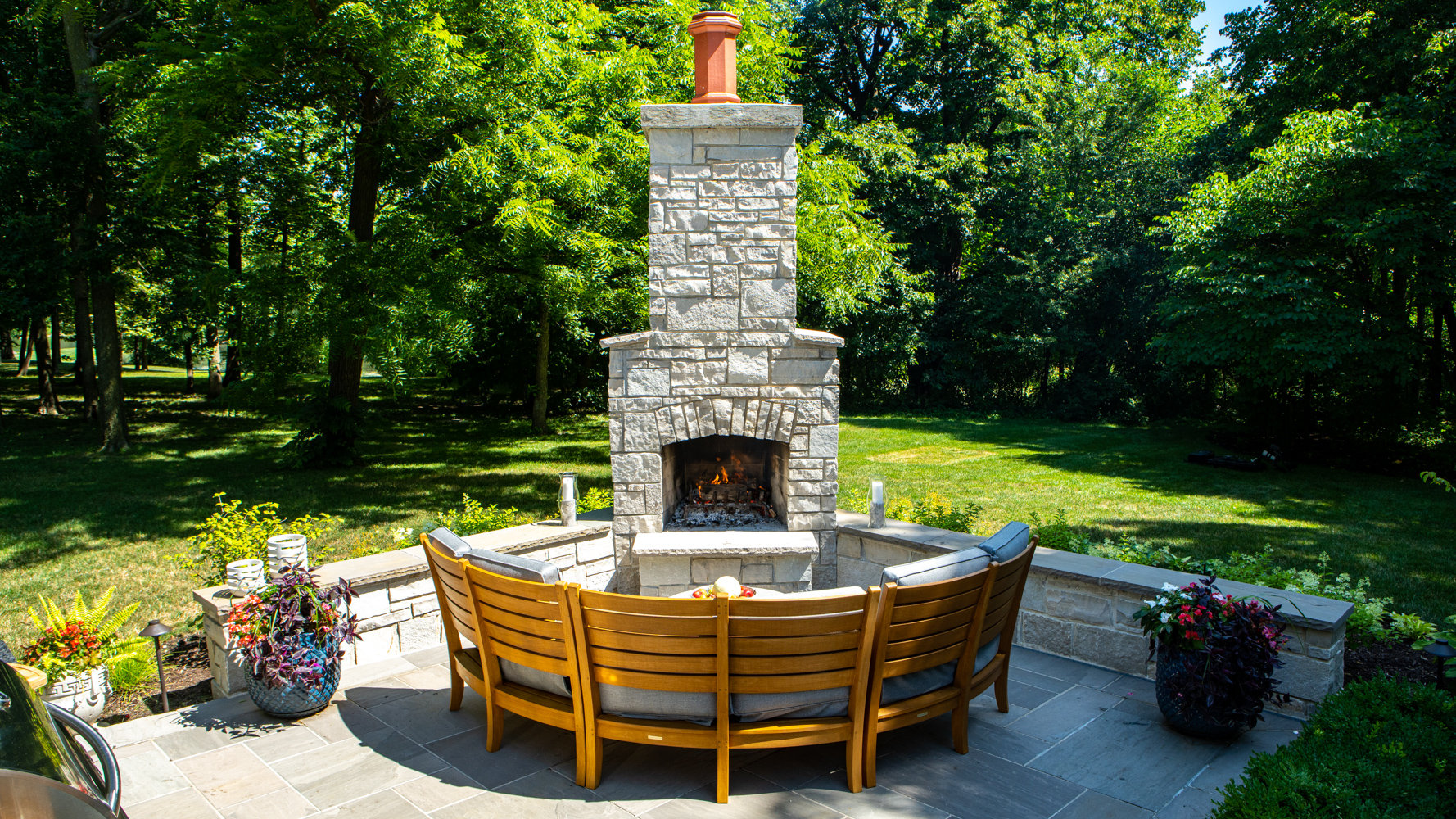 fire place-seating-patio-natural stone-seating wall-containers-lawn